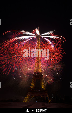 Le jour de la Bastille d'artifice Tour Eiffel Paris France fête de l'indépendance petite silhouette gendarme à base de la tour perspective ajoute que l'utilisation éditoriale Banque D'Images