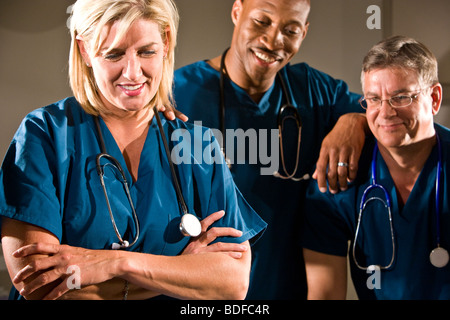 Close up of multi-ethnic doctors in blue scrubs Banque D'Images