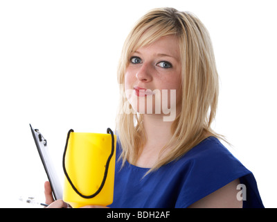 Jeune femme blonde de 20 ans portant un tabard bleu d'un organisme de bienfaisance worker holding out un boîte de collecte de charité Banque D'Images