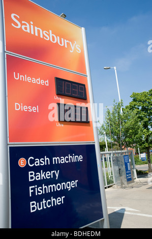 Inscrivez-vous à l'extérieur d'un supermarché Sainsburys et station essence montrant le prix du carburant. Banque D'Images