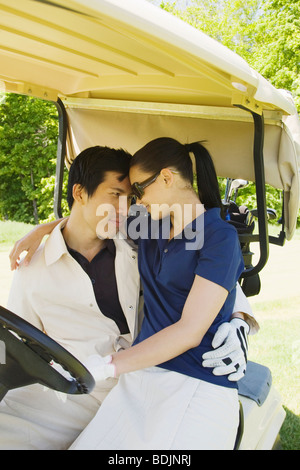 Couple in Golf Cart Banque D'Images