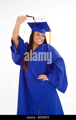 Une belle Caucasian teenager dans une graduation gown on a white background Banque D'Images