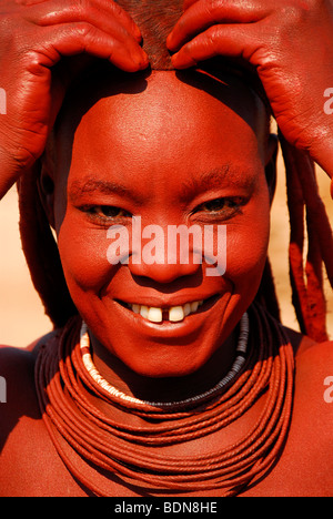 Femme Himba faisant ses cheveux, Purros, Kaokoveld, Namibie, Afrique du Sud Banque D'Images