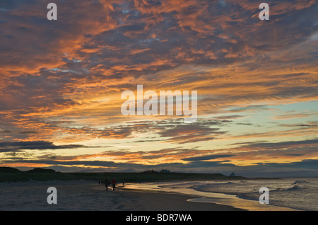 Coucher de soleil sur la côte de Northumberland à plage de Bamburgh. Banque D'Images