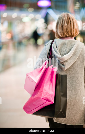 A woman carrying shopping bags Banque D'Images