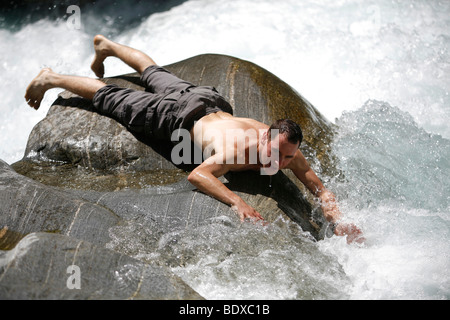 Tourist s'amusant et se rafraîchir en été aux rapides de la rivière Maggia, Tessin, Suisse, Europe Banque D'Images