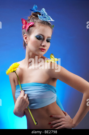 Portrait de beau modèle avec papillon et artificail bodyart papillons sur son doigt et sèche, holding flower dans sa main Banque D'Images