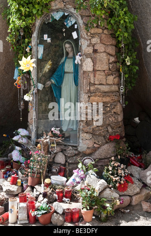 Route de culte avec statue de la Vierge Marie et les offrandes dans le nord de la Sardaigne, Italie Banque D'Images