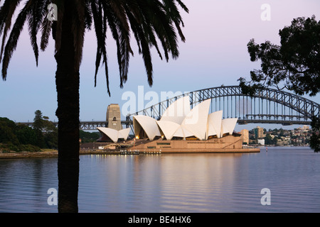 Crépuscule vue de l'Opéra de Sydney et le Harbour Bridge du Royal Botanic Gardens. Sydney, New South Wales, Australia Banque D'Images