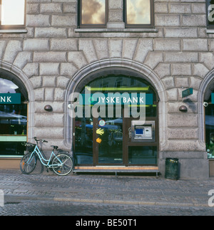 Vélo stationné à l'extérieur de l'ATM Jyske Bank et panneau sur la rue à Copenhague Danemark KATHY DEWITT Banque D'Images