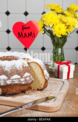 Un gâteau bundt, fleurs et une boîte-cadeau pour la Fête des Mères en Allemagne Banque D'Images