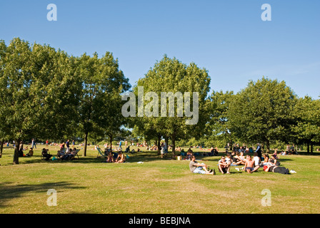 Les gens se détendre sur l'herbe sur une journée ensoleillée en été, Hyde Park London England UK Banque D'Images