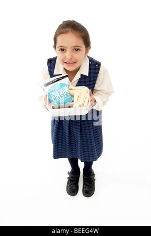 Studio Portrait of Smiling Girl Holding Lunch Banque D'Images