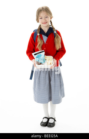 Studio Portrait of Smiling Girl Holding Lunch Banque D'Images