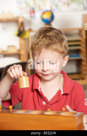 Jeune garçon jouant au préscolaire/Montessori Banque D'Images