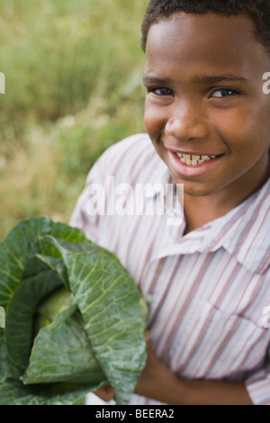 African boy holding cabbage Banque D'Images