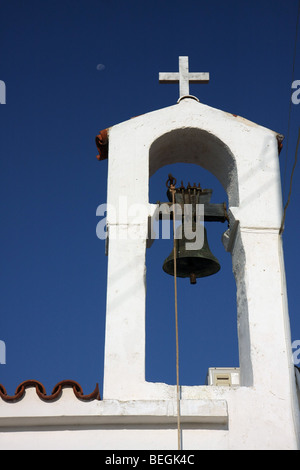 Le clocher de l'église Panagia à Protaras, Chypre. Vous pouvez voir la lune à gauche de la croix. Banque D'Images