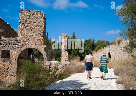 Village d'Assos Kefalonia - couple en train de marcher dans les ruines du château vénitien à l'intérieur des murs Banque D'Images