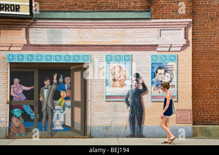 Woman walking in/off wall painting Cambridge, Massachusetts Banque D'Images