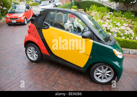 Smart car près d'un panneau routier à Lombard Street à San Francisco, un club de voiture rallye. Banque D'Images