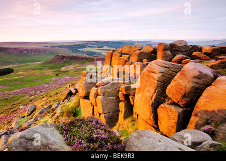 Higger Tor rocks illuminée par la lumière de l'été chaud l'aube dans le parc national de Peak District Banque D'Images