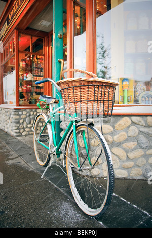 Cruiser vélo avec panier stationné à l'extérieur une devanture, Banff, Alberta, Canada. Banque D'Images