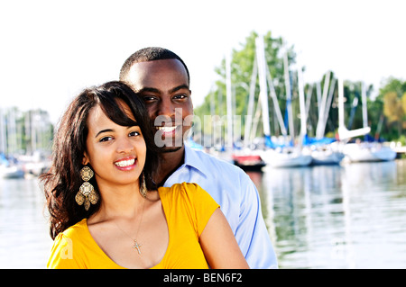 Portrait of young romantic couple standing at harbour Banque D'Images