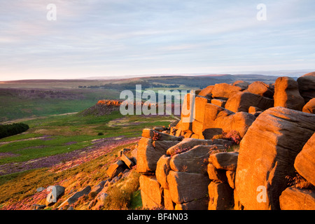 Higger Tor rocks illuminée par la lumière de l'été chaud l'aube dans le parc national de Peak District Banque D'Images