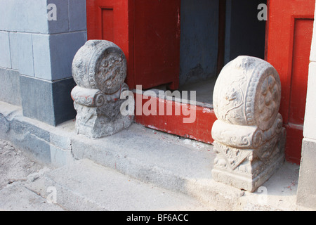 Une paire de Sculpté en pierre Mendun gardant la porte d'un Hutong courtyard House, Beijing, Chine Banque D'Images