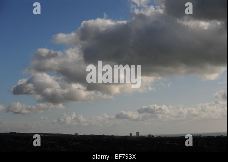 Storm clouds gathering contre un ciel bleu sur le front de mer de Brighton et Hove dans la distance Banque D'Images