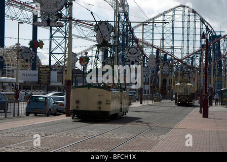 Les trams s'exécutant sur le Golden Mile avec Blackpool Pleasure Beach à l'arrière-plan. Banque D'Images