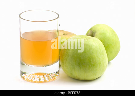 Le verre de jus et trois pommes vertes Banque D'Images