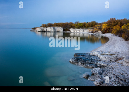 Reflet de falaises et de couleurs d'automne sur le lac Manitoba au coucher du soleil à rocher abrupt au Manitoba, Canada Banque D'Images