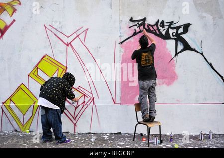 Paris, France, scène de rue, deux jeunes hommes adolescents, Graffers de rue, mur de peinture avec peinture en aérosol, Graffiti Banque D'Images