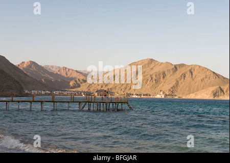 Coucher de soleil sur Taba Heights, Taba, Sinaï,rea sea, Egypt, Africa, avec les eaux bleu calme au premier plan et jetée de plongée. Banque D'Images