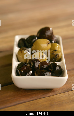 Trois types d'olives dans un plat blanc Banque D'Images