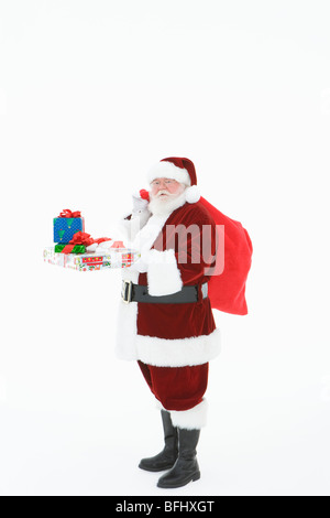 Santa Claus holding gifts Banque D'Images