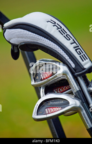 Un portrait photographie de clubs de golf dans un chariot de golf d'un fer et d'un bois montrant dans un couvercle de protection Banque D'Images