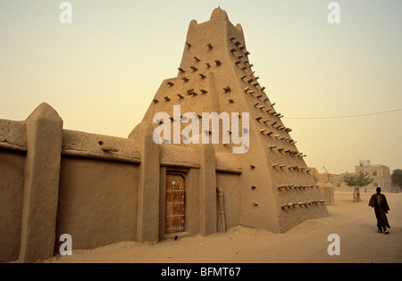 Mali, Tombouctou ou Tombouctou. Les promenades d'un homme passé de la ville le 15 e siècle la mosquée Sankoré construite de briques de terre cuite Banque D'Images