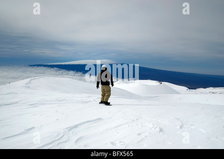 Snowboarder, volcan Mauna Kea, le Mauna Loa volcano dans la distance, point le plus élevé à Hawaii, 13796', la grande île d'Hawaï Banque D'Images