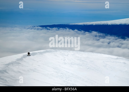 Snowboarder, volcan Mauna Kea, le Mauna Loa volcano dans la distance, point le plus élevé à Hawaii, 13796', la grande île d'Hawaï Banque D'Images