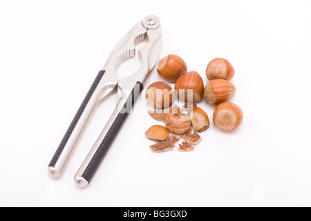 Ouvert aux noisettes avec nut cracker isolés contre fond blanc. Banque D'Images