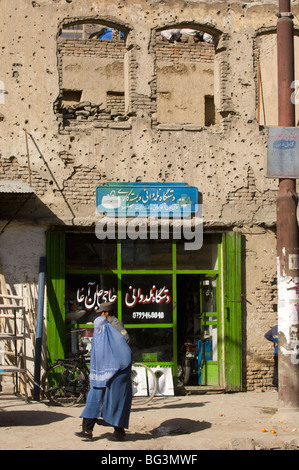 Femme marche afghane une balle marquée shop dans la ville de Kaboul, Afghanistan. Banque D'Images