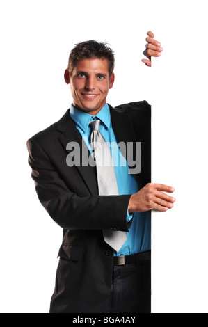 Young businessman holding a blank sign and smiling on a white background Banque D'Images
