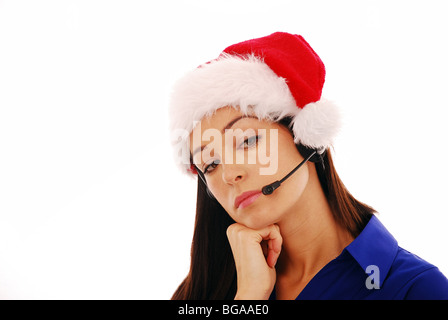 Young office worker wearing a Santa hat Banque D'Images