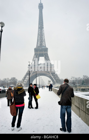 Paris, rue, France, Groupe moyen de personnes, debout, Teen touristes visitant la Tour Eiffel, en hiver personnes dans tempête de neige, à l'extérieur , Pont Banque D'Images