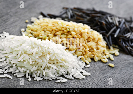Trois piles de blanc, marron et noir sauvage riz non cuit Banque D'Images