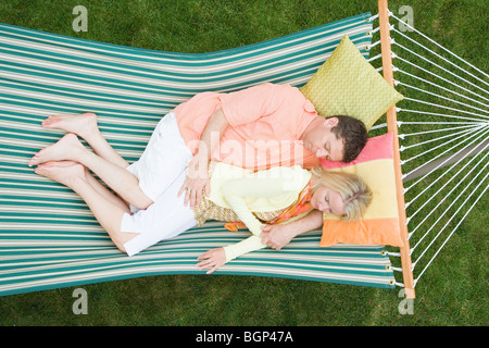 High angle view of a Mid adult woman sleeping with a young man in a hammock Banque D'Images