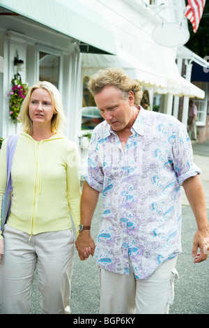 Mid adult woman and a young man holding hands Banque D'Images