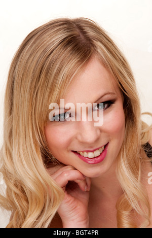 Timide blonde woman smiling Banque D'Images